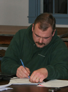 Select Board chair Jim Ameden signs the VSP contract for 25 hours of patrol a week.