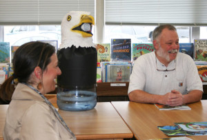 Christine Anderson, foreground, and CAES facilities manager Jim Spaulding flank an eagle-headed contraption that will be used to collect donations for the new playground at CAES. Photo by Cynthia Prairie.