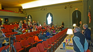 Weston Select Board members await the start of Town Meeting as residents find their seats. Photos by Christopher Biddle