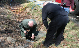 State Police Sargent Tom Williams (left) and State Fire Inspector Steve Otis examine an area where the fire began