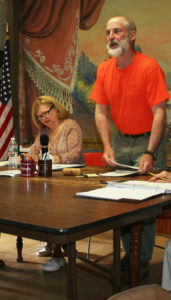 Al Sands stands as he addresses the audience as Town Administrator Emily Huff takes notes.