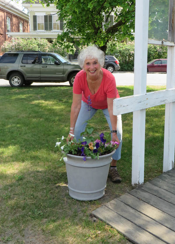 Chester Townscape member Cheryl LeClair moves a planted pot into position at the Chester Depot gazebo in spring 2015.