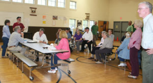 Select Board interim chair Al Sands, standing on left, explains how that evening's meeting was improperly warned.