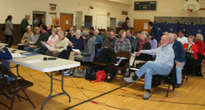 Members of the public filter into the elementary school gym for what will be a long Grafton Select Board meeting.
