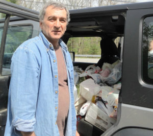 Chester letter carrier Tom Fournier with a jeep filled with food.