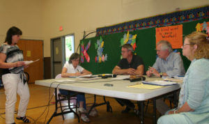 Grafton Town Clerk Kim Record presents the board with documents to hold the special election on July 12.