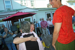 Lynne Reed gets a hug from bookseller Amanda Bourque