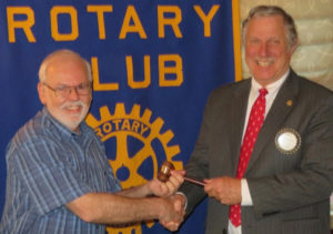 Bill Dakin, left, passes the gavel to new Chester Rotary President Ed Caron.