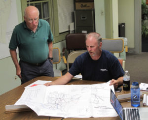 Planning Commission member Dick Dale, standing, and Road Foreman Duane Hart discuss.