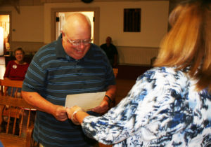 Ken Barrett receives an award for 35 years of service to the town from Town Clerk Deb Aldrich. Photos by Shawn Cunningham