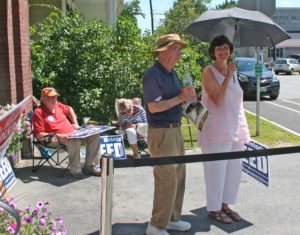 Tom Bock, seated, and Melody Reed, with umbrella, stand at the polls in Chester on Tuesday. Photos by Shawn Cunningham