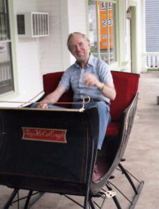 Coleman with a sleigh on the front porch of the Inn.