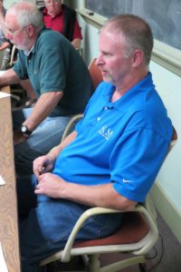 Road Foreman Duane Hart, foreground, discusses ways to save money on tree-cutting.