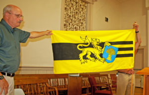 Tom Hildreth, left, and Frank Kelley exhibit the town flag given by David Sheuffleberg for the 250 celebration