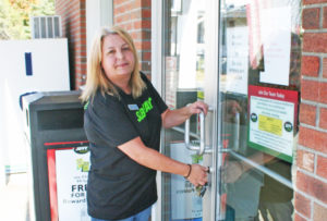 Store manager Michelle Page locks the door, closing the old Jiffy Mart