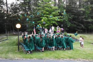 New graduates toss their caps in the air