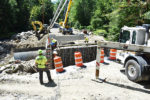 Workers pump concrete into forms for abutment #2 on Aug. 16, nearly a month behind schedule