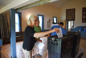 Nancy Juergens drops her ballot into the lockbox in Andover